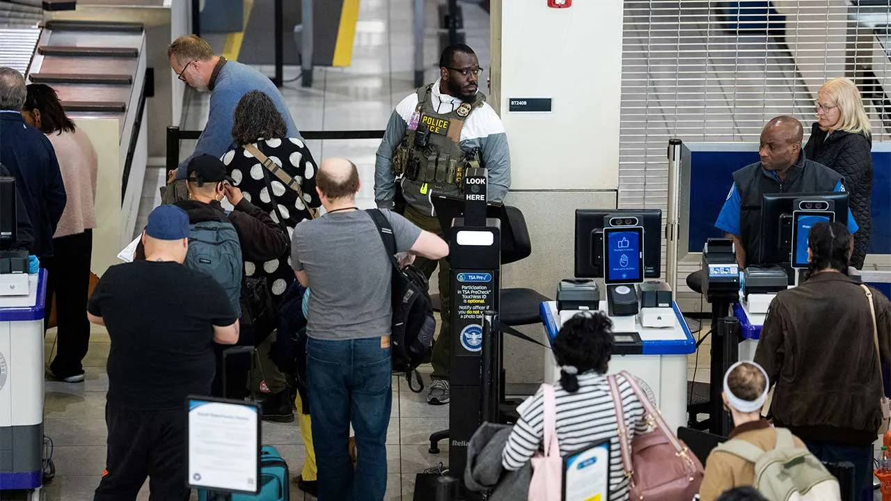 A U.S. Immigration and Customs Enforcement (ICE) agent patrols a TSA security checkpoint in Baltimore/Washington International Thurgood Marshall Airport (BWI) in Baltimore, Maryland, U.S., March 29, 2026. REUTERS/Aaron Schwartz