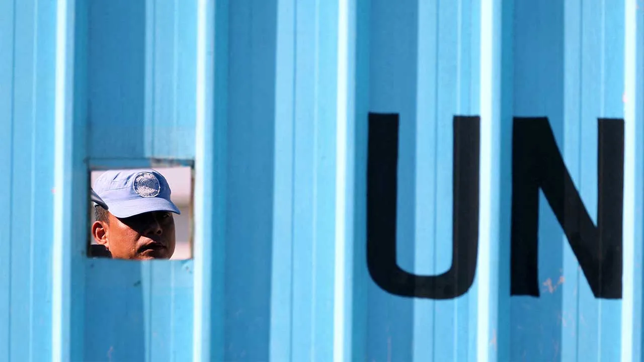 FILE PHOTO: A UN peacekeeper (UNIFIL) looks through an opening in Houla village near the border with Israel, in southern Lebanon, September 2, 2019. REUTERS/Ali Hashisho/File Photo