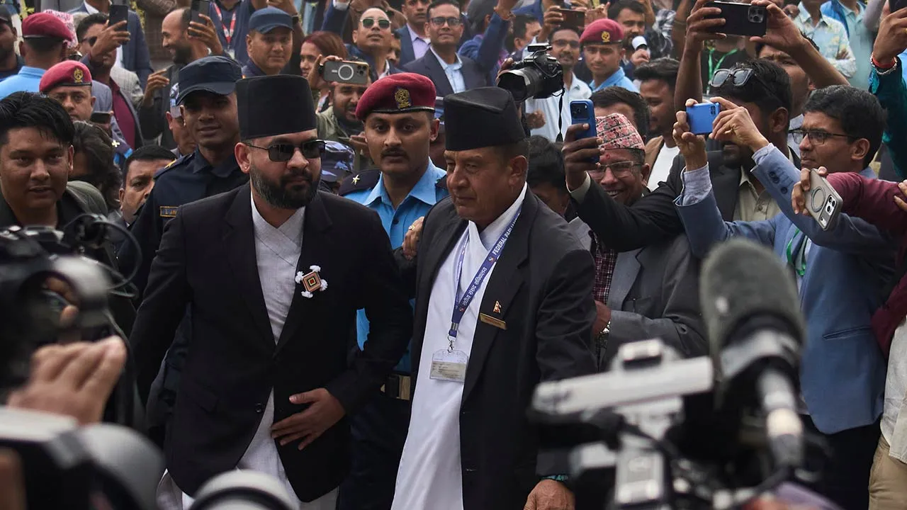 Balendra Shah, center left with sun glasses, arrives for a swearing-in ceremony of newly elected members of the House of Representatives at the Federal Parliament in Kathmandu, Nepal, Thursday, March 26, 2026. (AP Photo/Niranjan Shrestha)