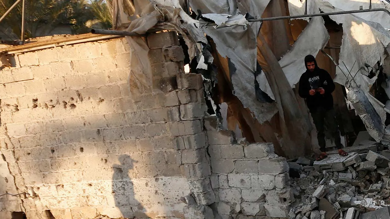 Palestinians inspect the damage following an Israeli strike near a tent camp sheltering displaced Palestinians in Deir al-Balah, in the central Gaza Strip, March 25, 2026. The Israeli military ordered the camp to evacuate before the strike, according to residents. REUTERS/Stringer