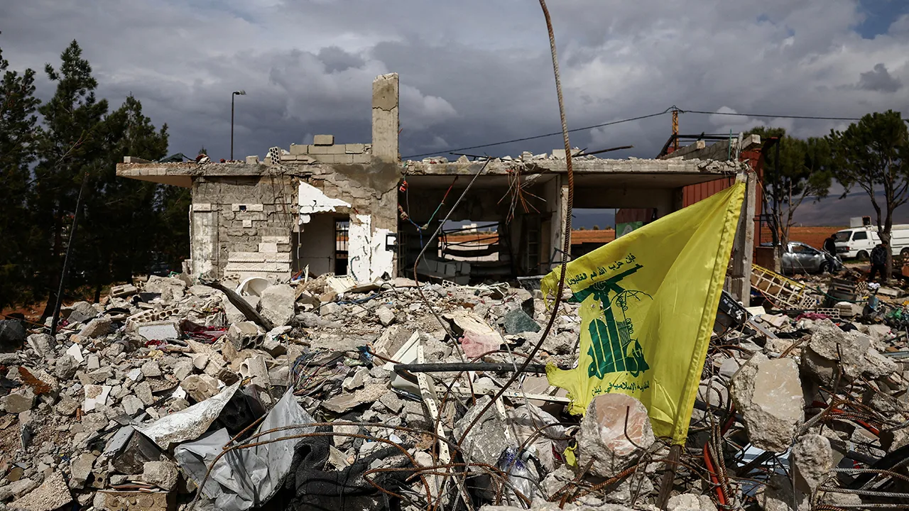 FILE PHOTO: A Hezbollah flag is placed in front of a house destroyed by an Israeli strike, following an escalation between Hezbollah and Israel, amid the U.S.-Israeli conflict with Iran, during a media tour in Chaat, Lebanon, March 23, 2026. REUTERS/Yara Nardi/File Photo