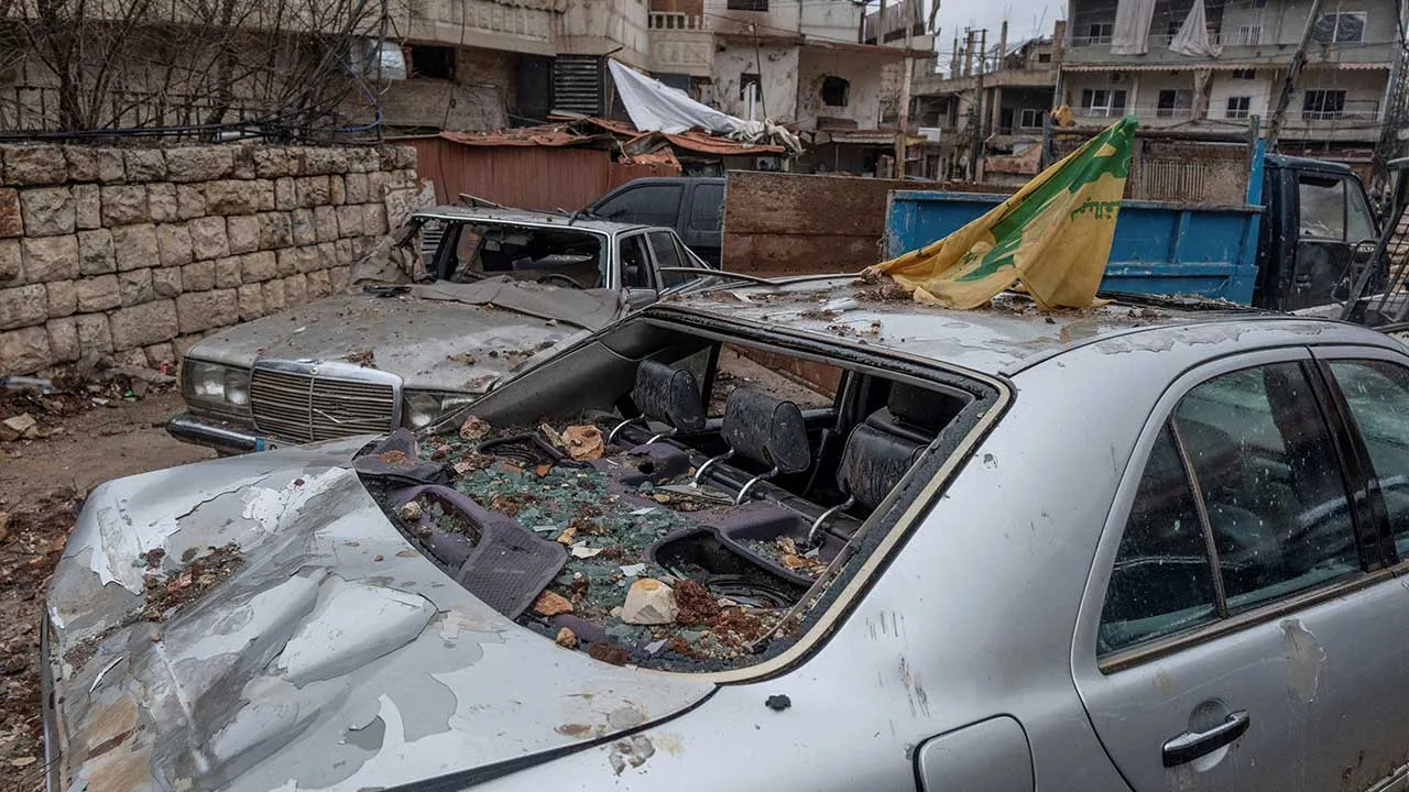 A Hezbollah flag is placed on a car destroyed by an Israeli strike, amid escalating hostilities between Israel and Hezbollah, as the U.S.-Israeli conflict with Iran continues, in Nabi Chit, Lebanon, March 26, 2026. REUTERS/Manu Brabo TPX IMAGES OF THE DAY