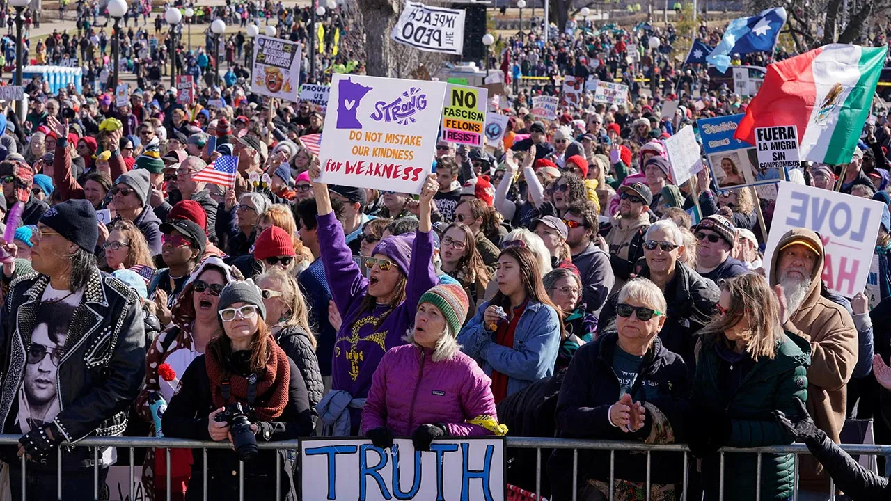 Demonstrators hold placards as they congregate at the Minnesota State Capitol during a "No Kings" protest against U.S. President Donald Trump's administration policies, in St. Paul, Minnesota, U.S., March 28, 2026. REUTERS/Erica Dischino