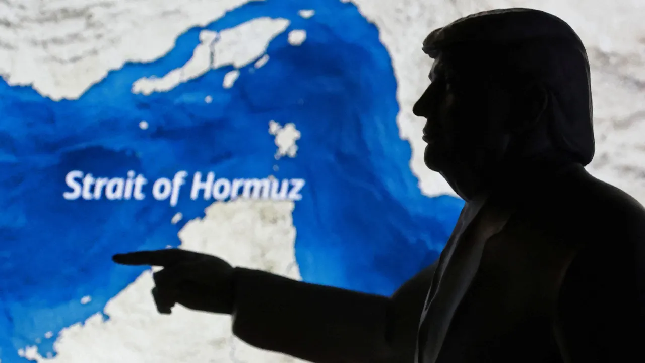 A map showing the Strait of Hormuz and a 3D-printed miniature model depicting U.S. President Donald Trump are seen in this illustration taken March 23, 2026. REUTERS/Dado Ruvic/Illustration