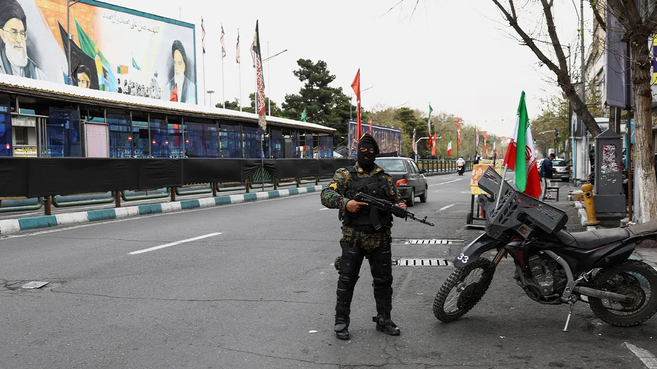 A member of a police force stands guard on a street, amid the U.S.-Israeli conflict with Iran, in Tehran, Iran, March 23, 2026. Majid Asgaripour/WANA (West Asia News Agency) via REUTERS ATTENTION EDITORS - THIS PICTURE WAS PROVIDED BY A THIRD PARTY