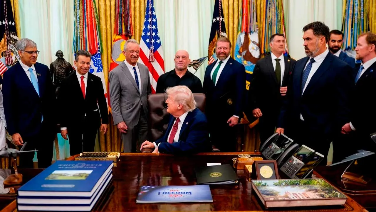 President Donald Trump signs an executive order about easing restrictions on psychedelics in mental health treatment, while surrounded by NIH Director Jay Bhattacharya, FDA head Marty Makary, US Secretary Robert F. Kennedy Jr., podcaster Joe Rogan, and Ibogaine advocates in the Oval Office of the White House in Washington, DC, on Saturday. Nathan Howard/Reuters
