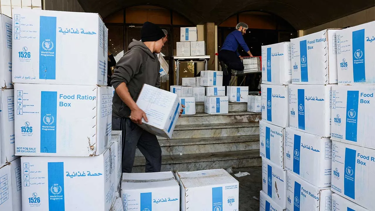 Volunteers carry World Food Programme (WFP) boxes of aid supplies in a school-turned-shelter in Beirut, following an escalation between Hezbollah and Israel amid the U.S.-Israeli conflict with Iran, Lebanon, March 12, 2026. REUTERS/Mohamed Azakir