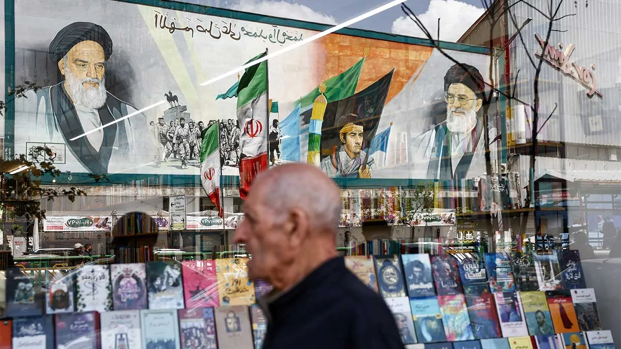 A mural depicting the late leader of the Islamic Revolution Ayatollah Ruhollah Khomeini and the late Supreme Leader of Iran Ayatollah Ali Khamenei is reflected in a bookshop window display, amid the U.S.-Israeli conflict with Iran, in Tehran, Iran, April 5, 2026. Majid Asgaripour/WANA (West Asia News Agency) via REUTERS ATTENTION EDITORS - THIS PICTURE WAS PROVIDED BY A THIRD PARTY