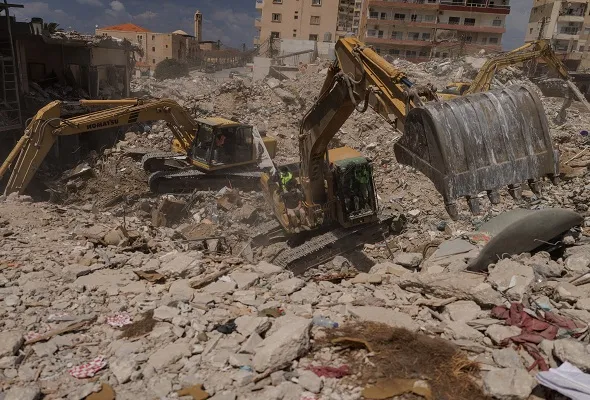 Civil defence members search for bodies under the rubble of buildings hit by an Israeli strike just before the ceasefire, amid a 10-day ceasefire between Lebanon and Israel, in Tyre, southern Lebanon.