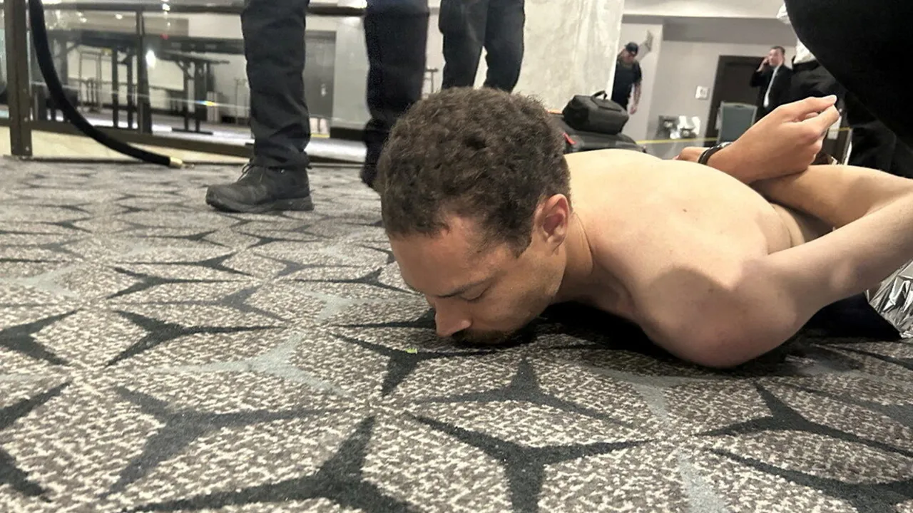 Law enforcement personnel detain Cole Tomas Allen, a suspect in the shooting incident at the White House Correspondents' Association dinner, in Washington, D.C., U.S. April 25, 2026. DONALD J TRUMP via Truth Social/Handout via REUTERS THIS IMAGE HAS BEEN SUPPLIED BY A THIRD PARTY. MANDATORY CREDIT. REFILE - ADDING NAME OF THE SUSPECTED SHOOTER VERIFICATION: Reuters was able to verify the location from flooring and windows that match corroborating footage. Date confirmed from the government statement of the 