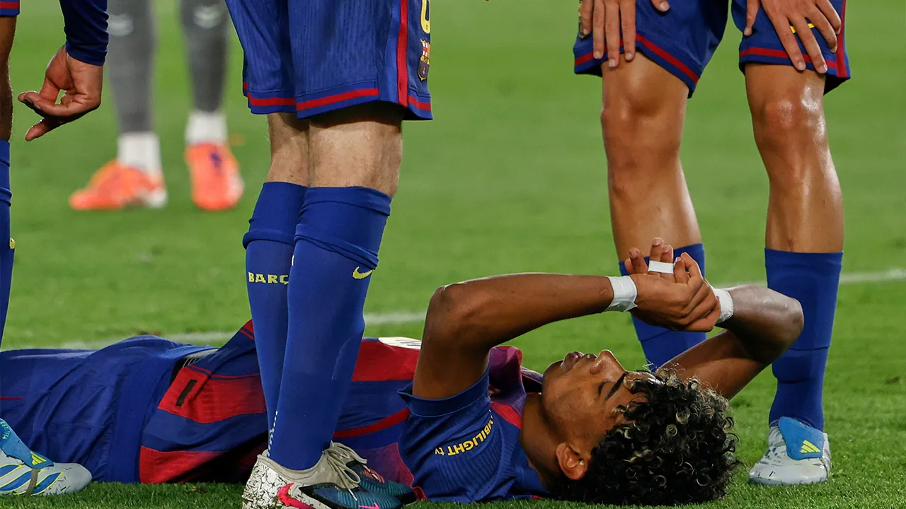 Barcelona's Lamine Yamal lays on the pitch after getting injured during the Spanish La Liga soccer match between Barcelona and Celta Vigo in Barcelona, Spain, Wednesday, April 22, 2026. (AP Photo/Joan Monfort)