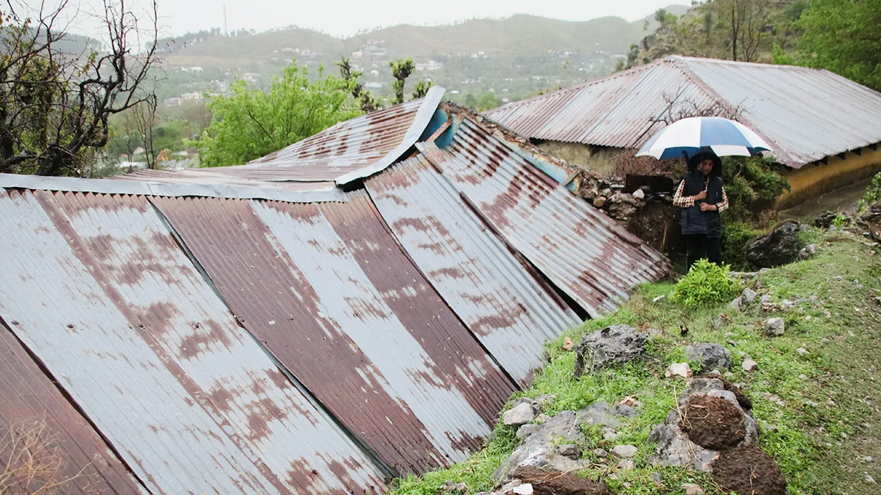 A person walks past the roof of a house, collapsed after heavy rains in Abbottabad, Khyber Pakhtunkhwa province in Pakistan March 30, 2026. REUTERS/Sultan Dogar