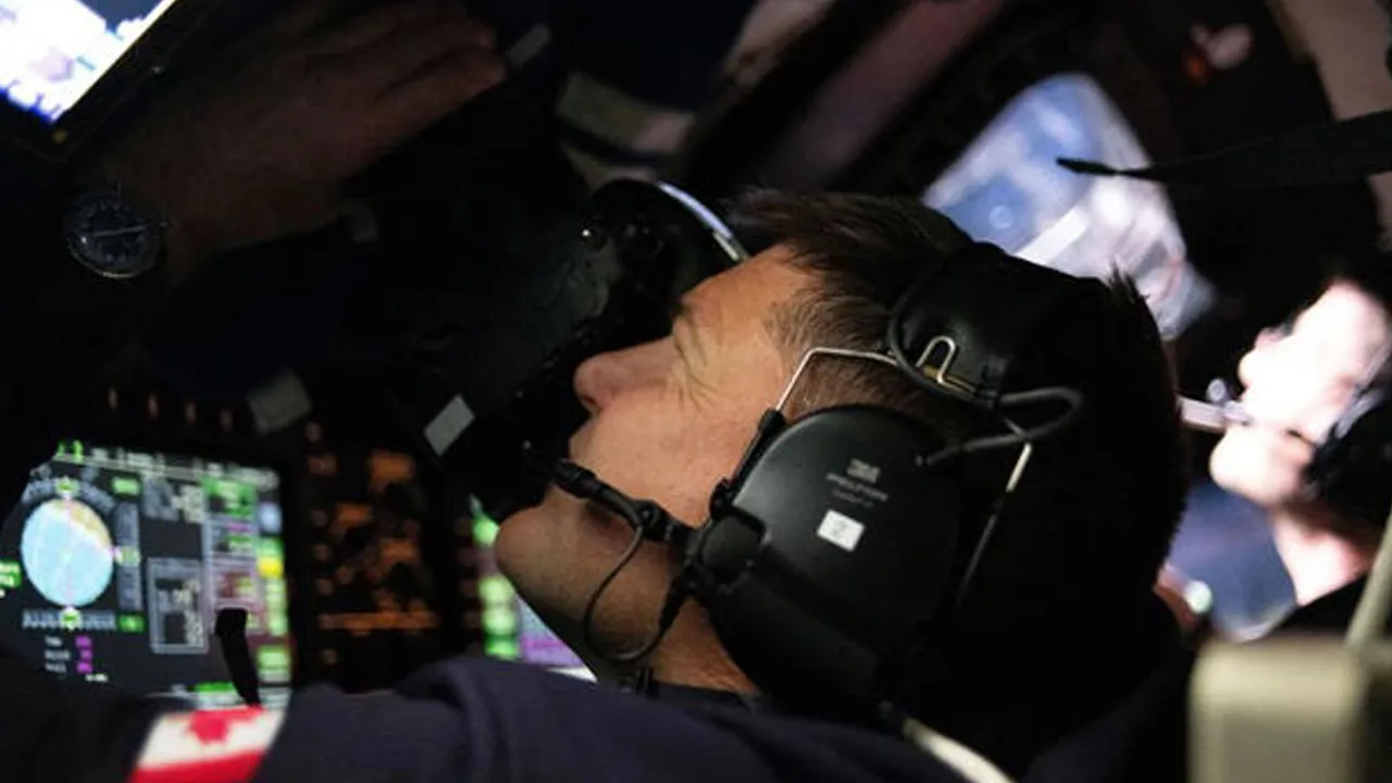 Canadian Space Agency (CSA) astronaut and Artemis II Mission Specialist Jeremy Hansen takes photographs through the Orion spacecraft's window during the Artemis II crew’s flyby of the Moon April 6, 2026. Picture released April 7, 2026. NASA/Handout via REUTERS
