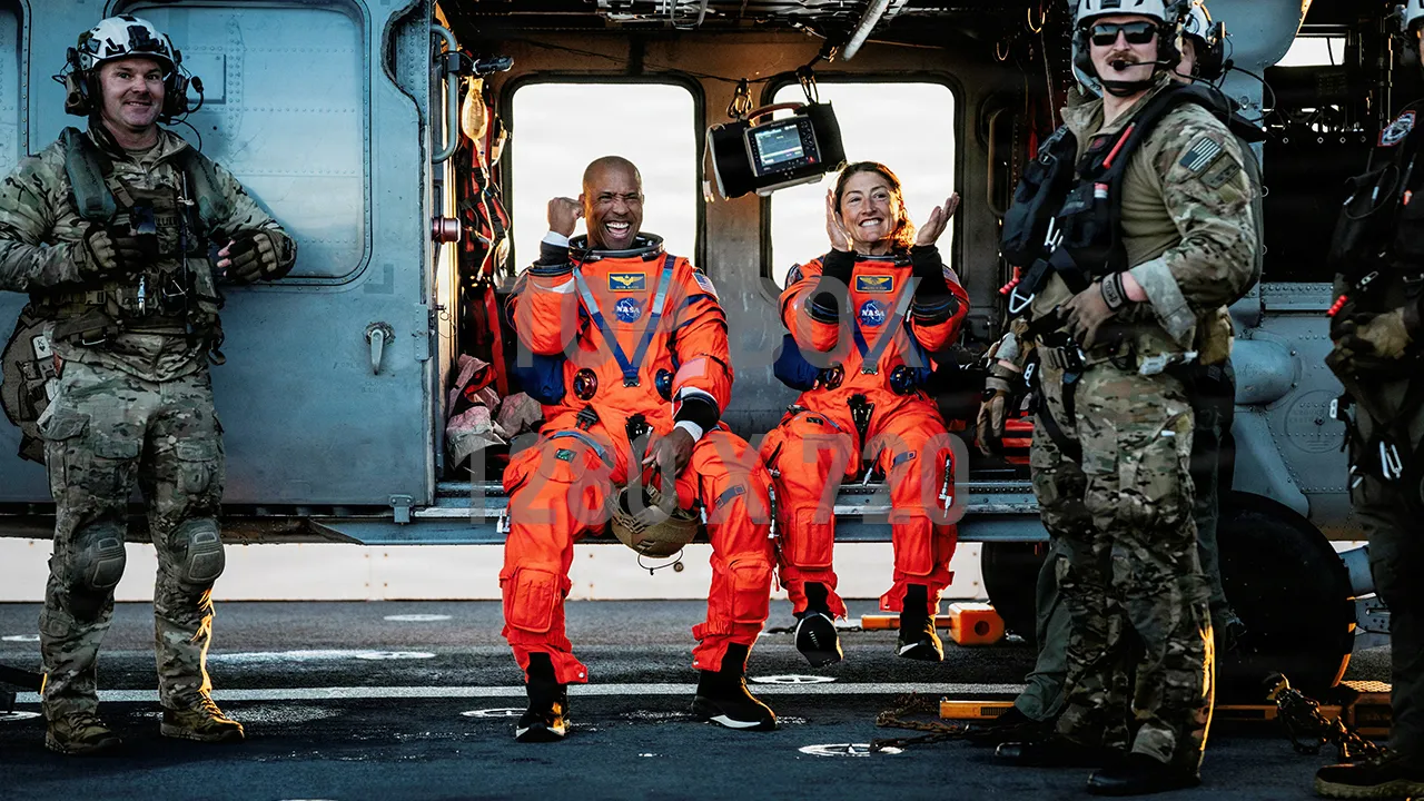 NASA astronauts Victor Glover and Christina Koch sit in a U.S. Navy MH-60S Seahawk on the flight deck of the U.S. Navy's USS John P. Murtha after returning from their Artemis II Moon flyby mission's Orion capsule, which splashed down in the Pacific Ocean off the coast of California, U.S. April 10, 2026. U.S. Navy/Mass Communication Specialist 2nd Class August Clawson/Handout via REUTERS