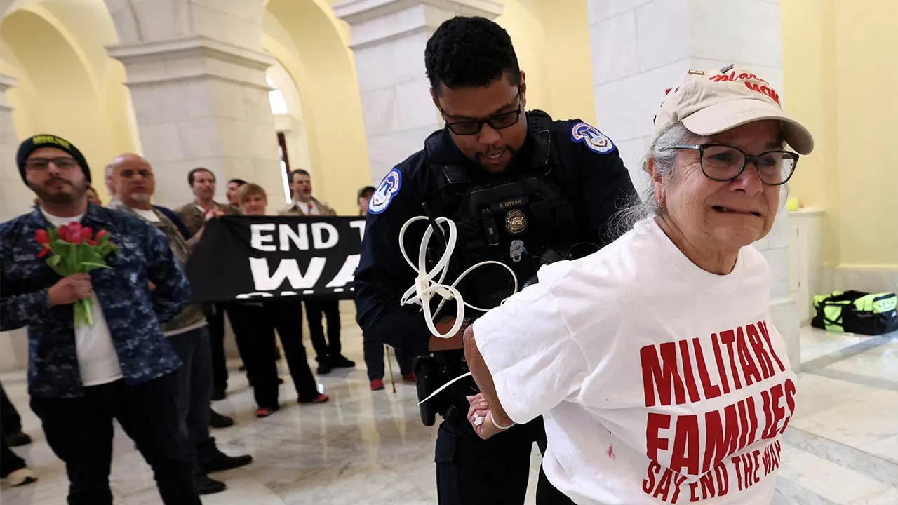 A protester hands are zip-tied during a protest against the Iran war by veterans from the group About Face and members of military families in the Cannon House Office Building Rotunda on Capitol Hill in Washington, D.C., U.S., April 20, 2026. REUTERS/Kevin Lamarque TPX IMAGES OF THE DAY