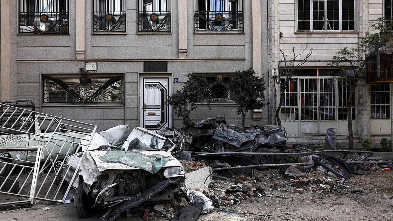 Car wrecks and a residential building damaged by a strike amid the U.S.-Israeli conflict with Iran, in Tehran, Iran, March 30, 2026. Majid Asgaripour/WANA (West Asia News Agency) via REUTERS ATTENTION EDITORS - THIS PICTURE WAS PROVIDED BY A THIRD PARTY