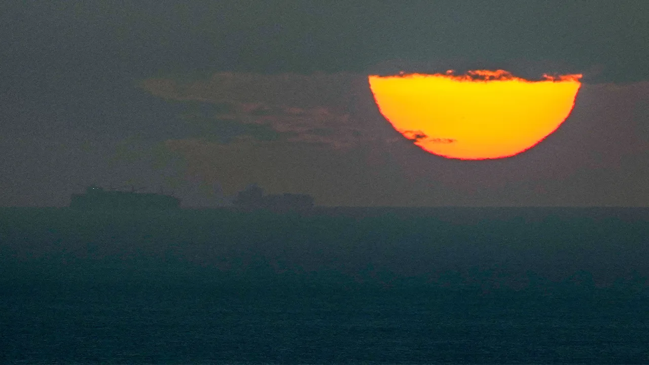 FILE - Ships sail through the Arabian Gulf toward the Strait of Hormuz as the sun sets in the United Arab Emirates Monday, March 23, 2026. (AP Photo, File)