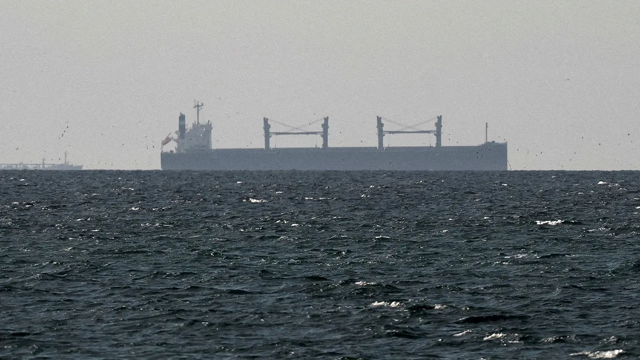 FILE PHOTO: A cargo ship in the Gulf, near the Strait of Hormuz, as seen from northern Ras al-Khaimah, near the border with Oman’s Musandam governance, amid the U.S.-Israeli conflict with Iran, in United Arab Emirates, March 11, 2026. REUTERS/Stringer/File Photo/File Photo/File Photo