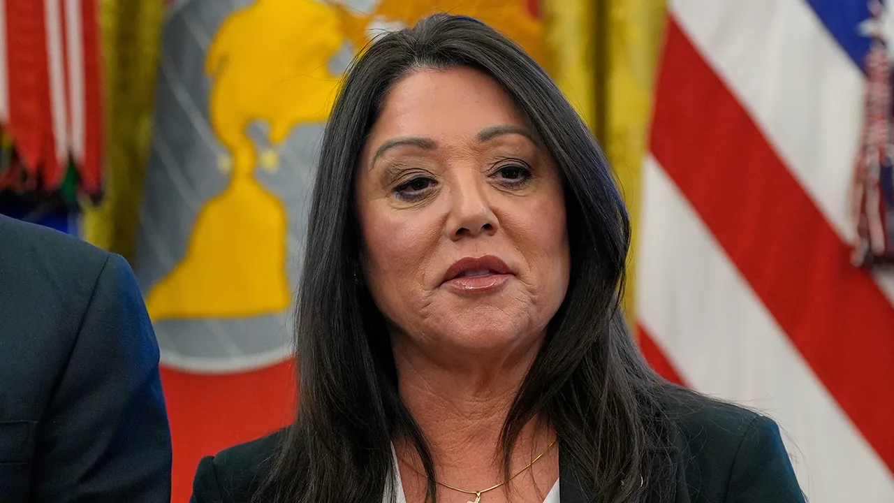 Labor Secretary Lori Chavez-DeRemer listens as President Donald Trump speaks with reporters while signing executive orders in the Oval Office of the White House, April 23, 2025, in Washington. (AP Photo/Alex Brandon, File)