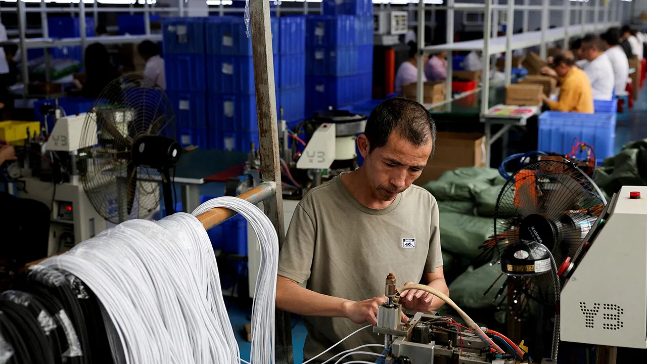 An employee works on USB cables production at a plastic accessories factory, as rising oil prices drive up production costs for plastic manufacturers, in Dongguan, Guangdong province, China, April 2, 2026. REUTERS/Go Nakamura/File Photo