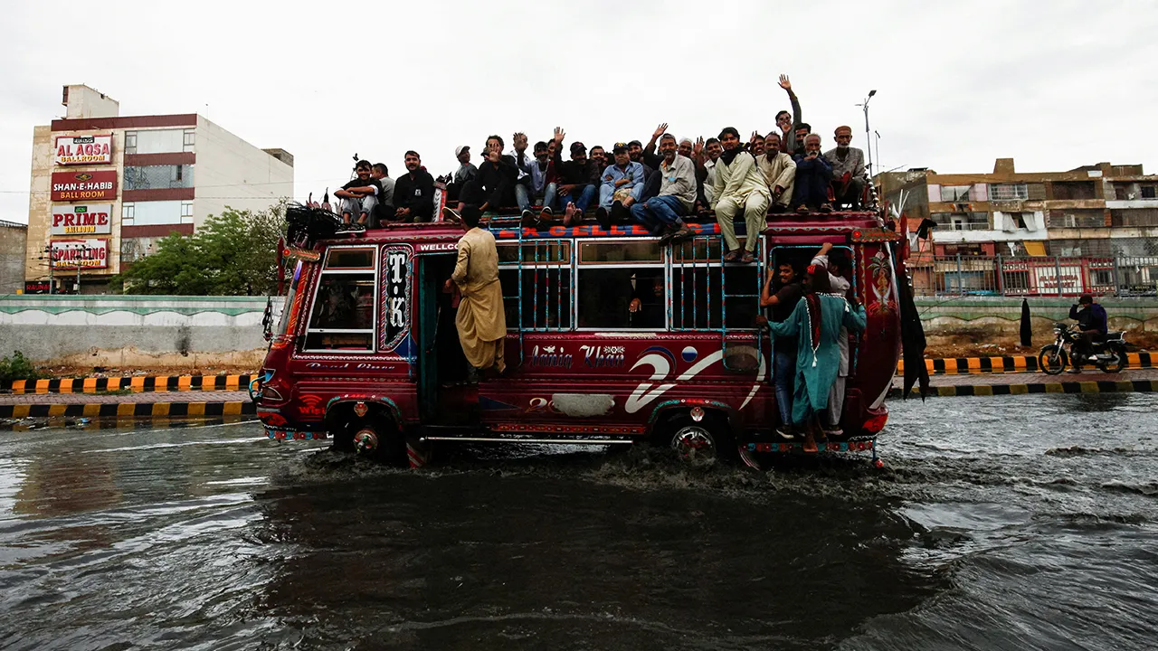 Commuters ride in an overcrowded bus along a flooded street following torrential rain in Karachi, Pakistan, April 2, 2026. REUTERS/Qaiser Khan TPX IMAGES OF THE DAY