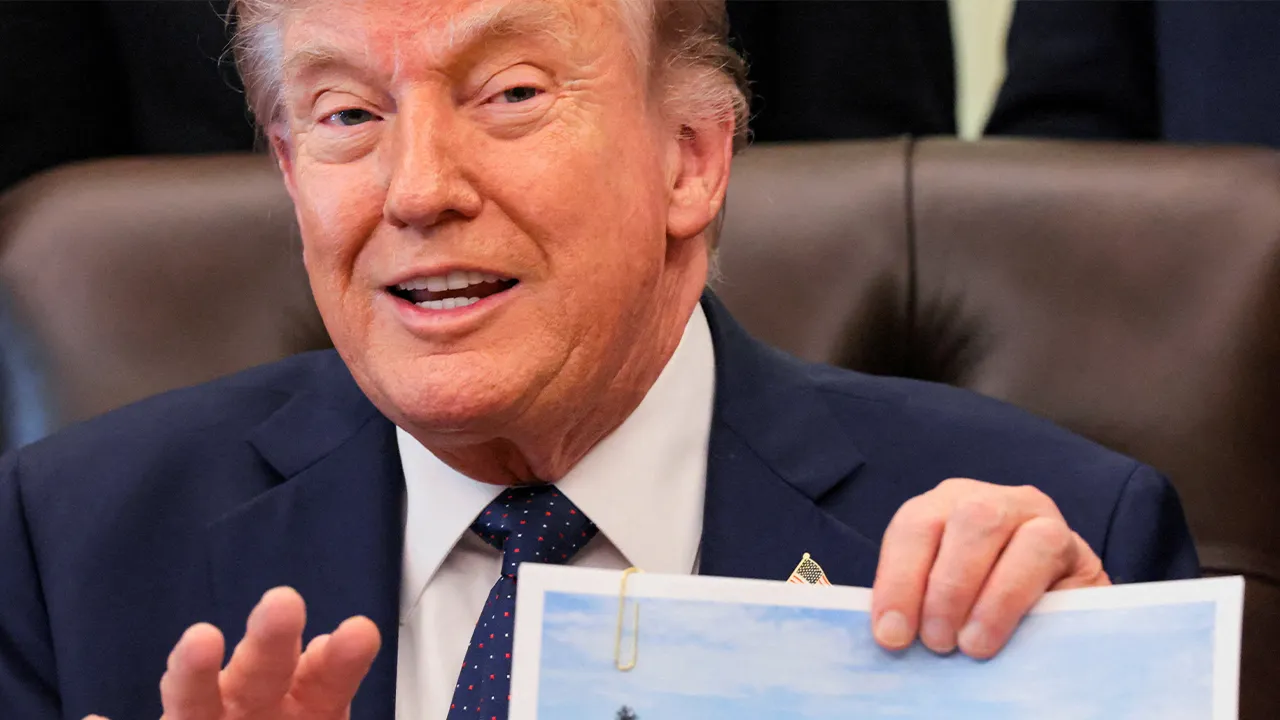 U.S. President Donald Trump shows an image as he speaks about renovations at the Lincoln Memorial Reflecting Pool during a healthcare affordability event in the Oval Office at the White House in Washington, D.C., U.S., April 23, 2026. REUTERS/Kylie Cooper