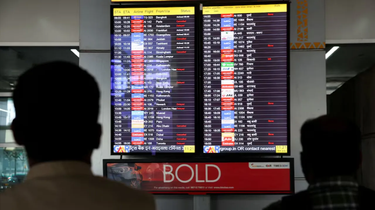 People look at a screen displaying flight information at the Indira Gandhi International airport, amid the U.S.-Israel conflict with Iran, in New Delhi, India, March 3, 2026. REUTERS/Bhawika Chhabra/File Photo