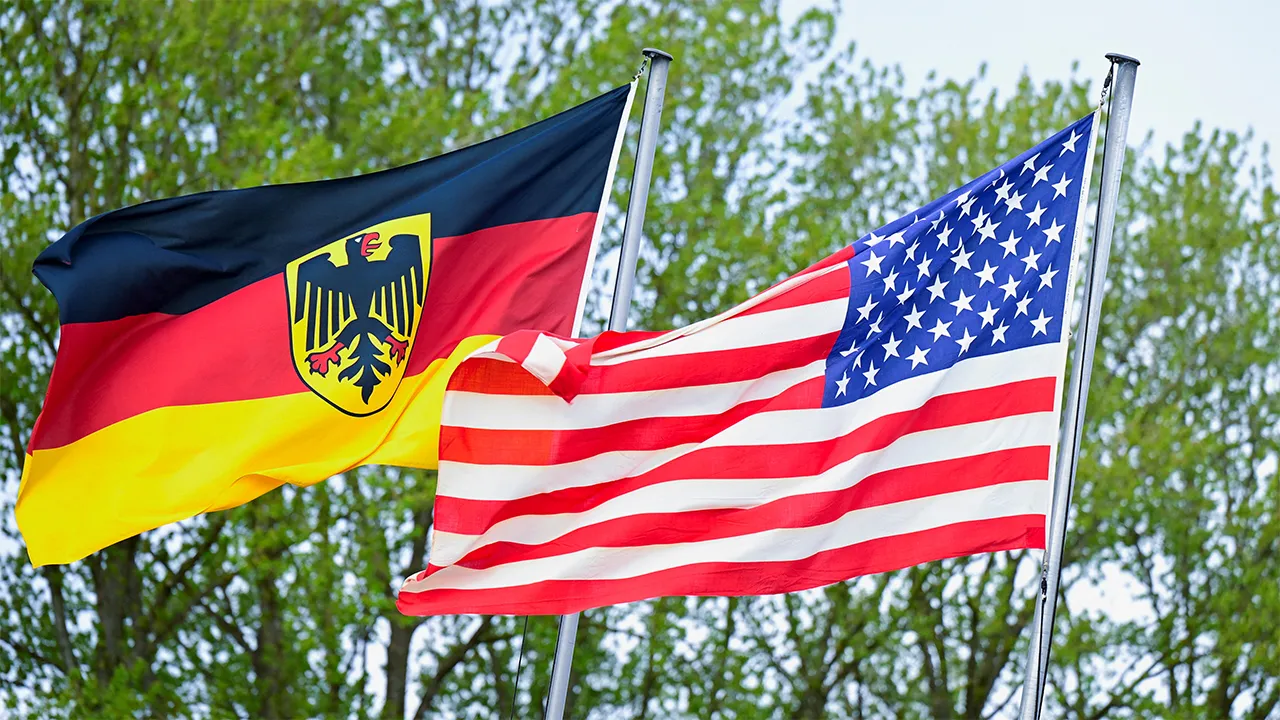 The German flag featuring the Federal Eagle and the U.S. flag are pictured at the German Navy base in Kiel, Germany, April 23, 2026. REUTERS/Fabian Bimmer