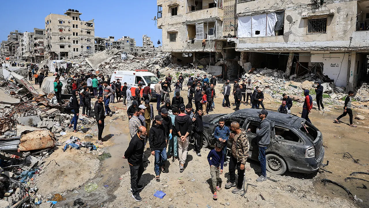 Palestinians inspect the damage after a person was hit by an Israeli strike while riding a bicycle, according to medics, in Gaza City, April 6, 2026. REUTERS/Dawoud Abu Alkas