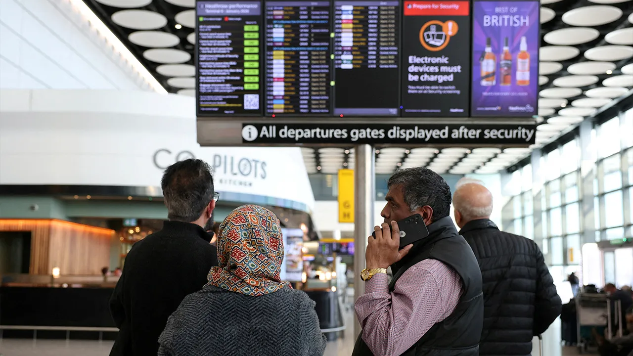 Travellers check on a departure board displaying cancelled flights to Middle East countries amid the U.S.-Israel conflict with Iran, at Heathrow Airport Terminal 4, in Greater London, Britain, March 2, 2026. REUTERS/Isabel Infantes