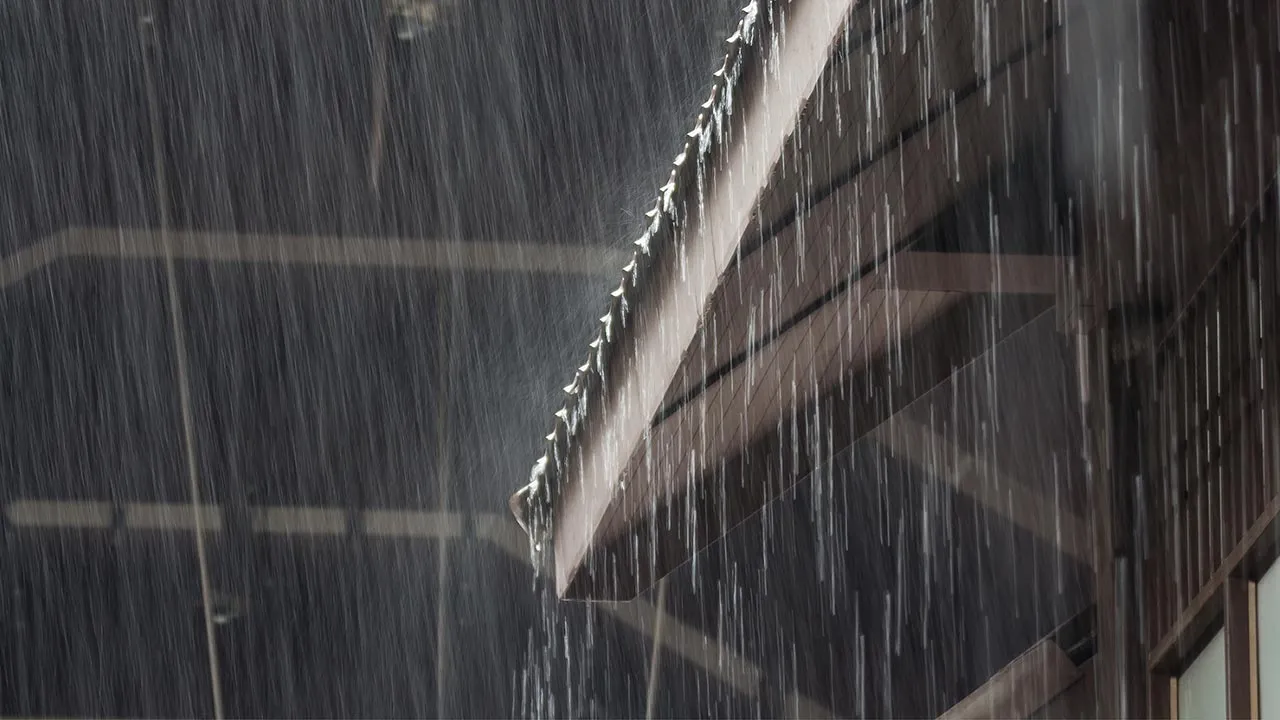 heavy rain on roof of wooden house, rainy season -- Adobe Stock Image
