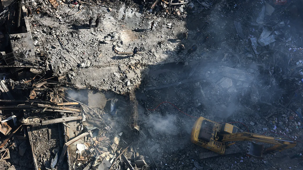 People stand as an excavator operates at the site of an Israeli strike carried out on Wednesday, in Al-Mazraa in Beirut, Lebanon, April 9, 2026. REUTERS/Raghed Waked TPX IMAGES OF THE DAY