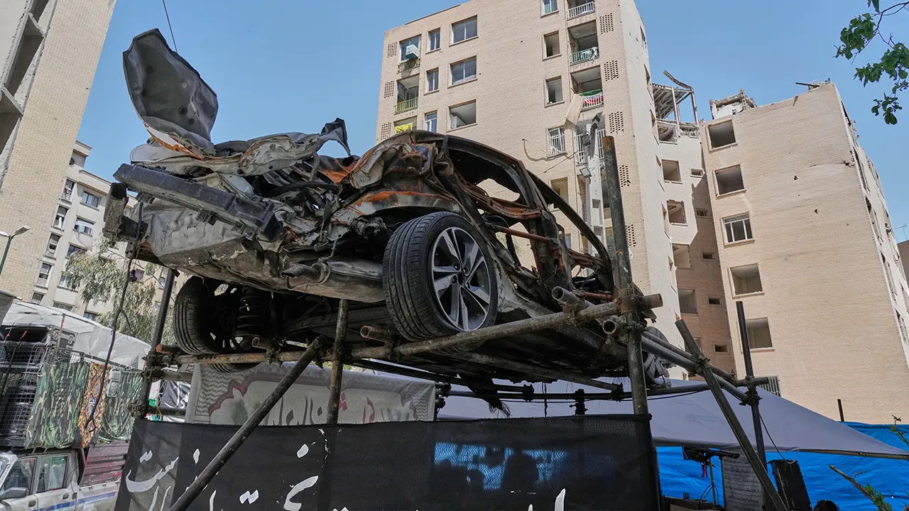 A damaged car is displayed in a residential compound that, according to the authorities, was struck on March 4 during the U.S.-Israeli military campaign, in southeastern Tehran, Iran, Tuesday, April 14, 2026. (AP Photo/Vahid Salemi)