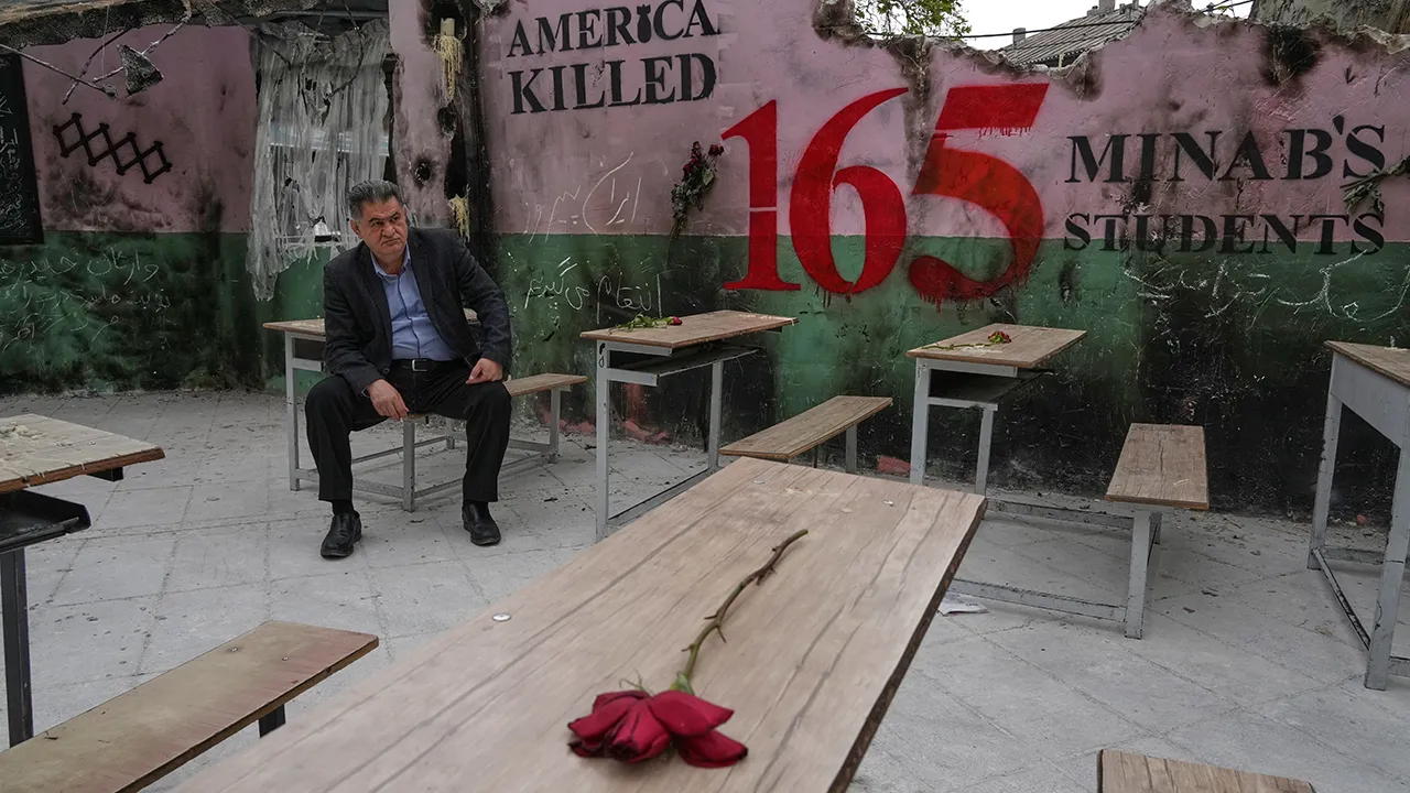 A man sits on a bench in a memorial, set for the school children who were killed during a strike on a school in southern town of Minab on Feb. 28, in northern Tehran, Iran, Sunday, April 12, 2026. (AP Photo/Vahid Salemi)