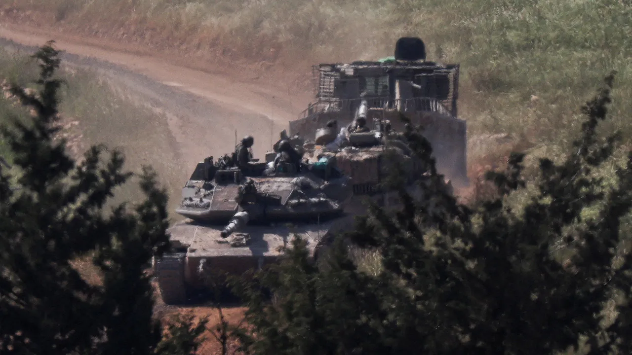 Tanks and an armoured vehicle drive in Lebanon, as seen from the Israeli side of the Israel-Lebanon border, in northern Israel, April 25, 2026. REUTERS/Florion Goga