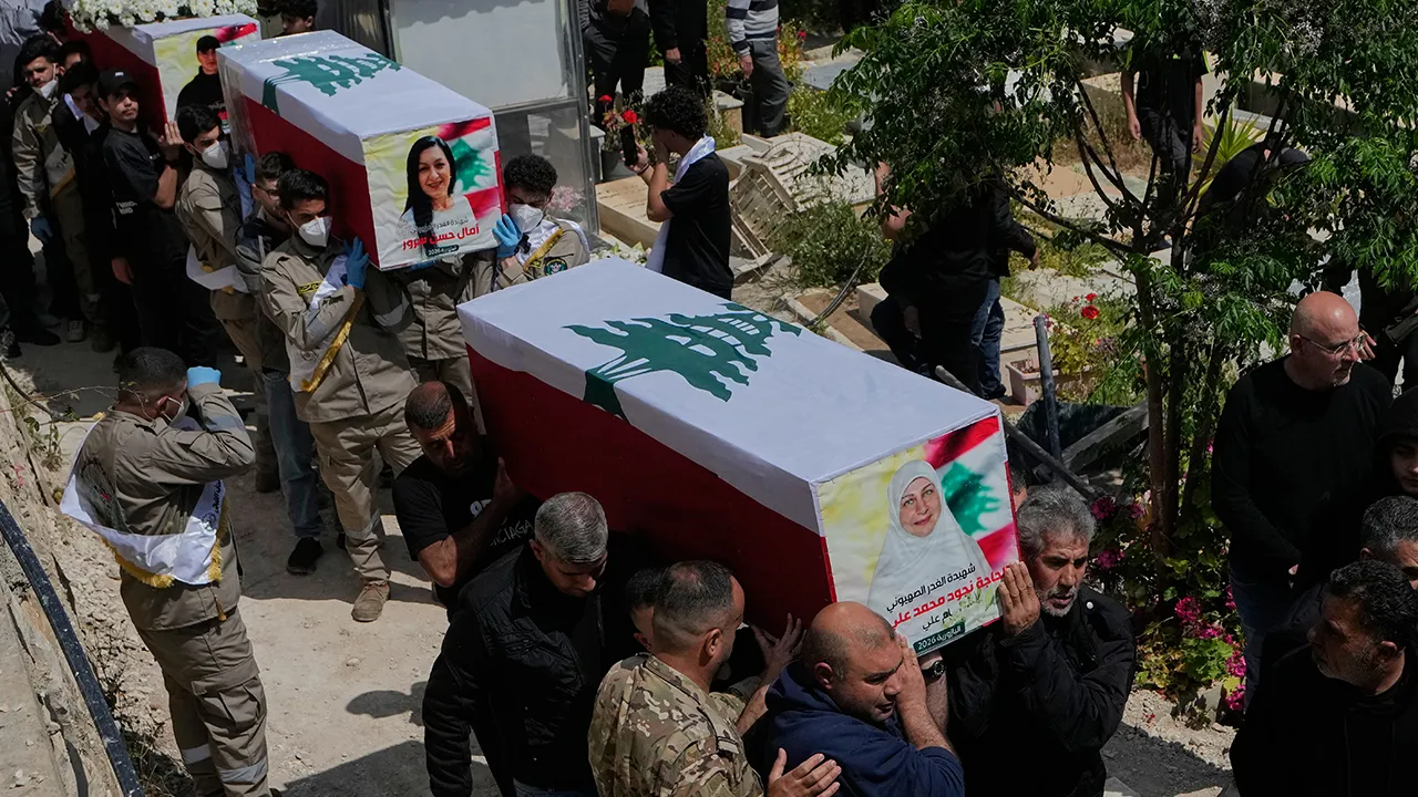 Mourners carry the coffins of civilians who were killed in the war between Hezbollah and Israel during a mass funeral in Bazouriyeh village, south Lebanon, Monday, April 20, 2026. (AP Photo/Mohammed Zaatari)