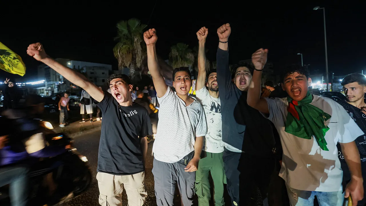 A group of men celebrates as displaced people return to their homes after a 10-day ceasefire between Lebanon and Israel went into effect, in Sidon, Lebanon, April 17, 2026. REUTERS/Aziz Taher