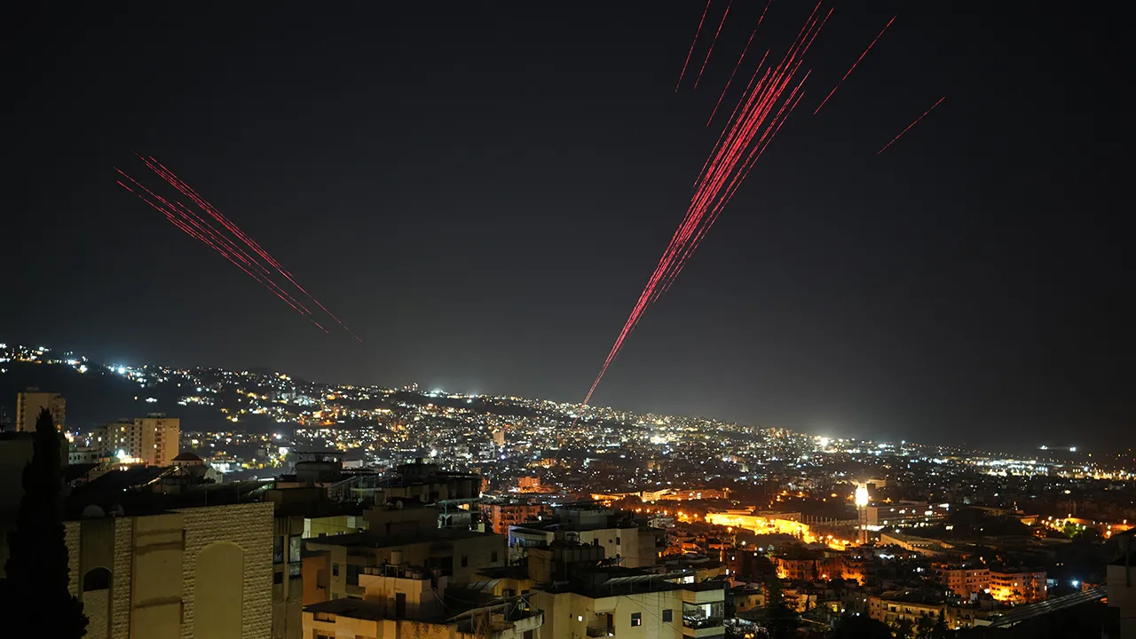 Tracer rounds illuminate the night sky as people fire live ammunition and fireworks into the air following a ceasefire between Israel and Hezbollah, in Beirut, Lebanon, early Friday, April 17, 2026. (AP Photo/Hassan Ammar)