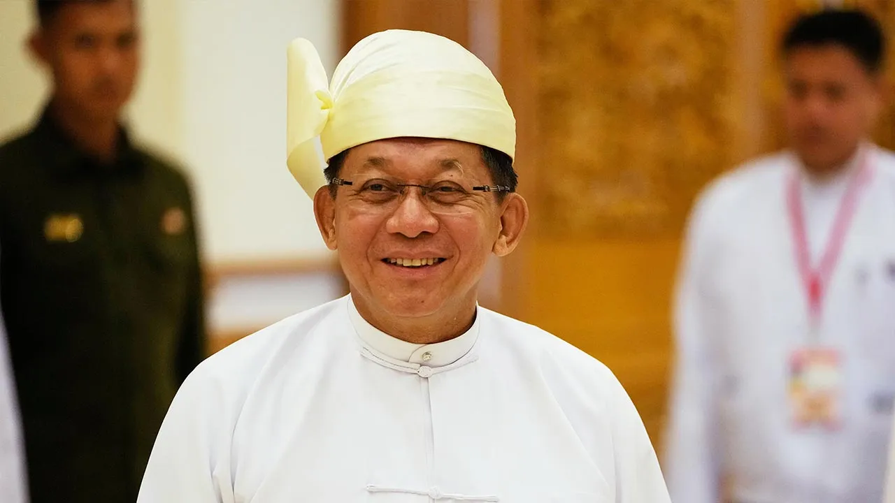 Myanmar's newly elected President Min Aung Hlaing talks to journalists as he leaves after a swearing-in ceremony at Union Parliament in Naypyitaw, Myanmar, Friday, April 10, 2026. (AP Photo/Aung Shine Oo)