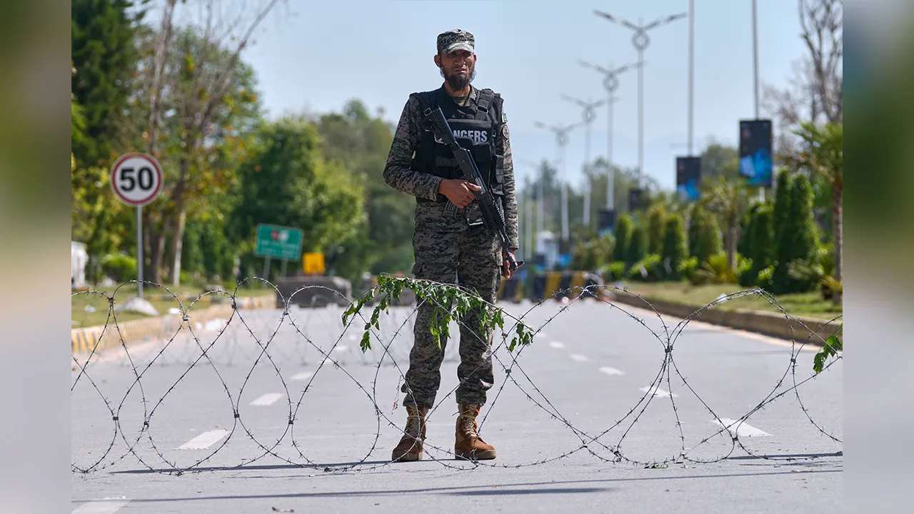 A paramilitary soldier stands guard at a checkpoint to ensure security ahead of the United States and Iran possible negotiations in Pakistani capital, in Islamabad, Pakistan, Friday, April 10, 2026. (AP Photo/Anjum Naveed)