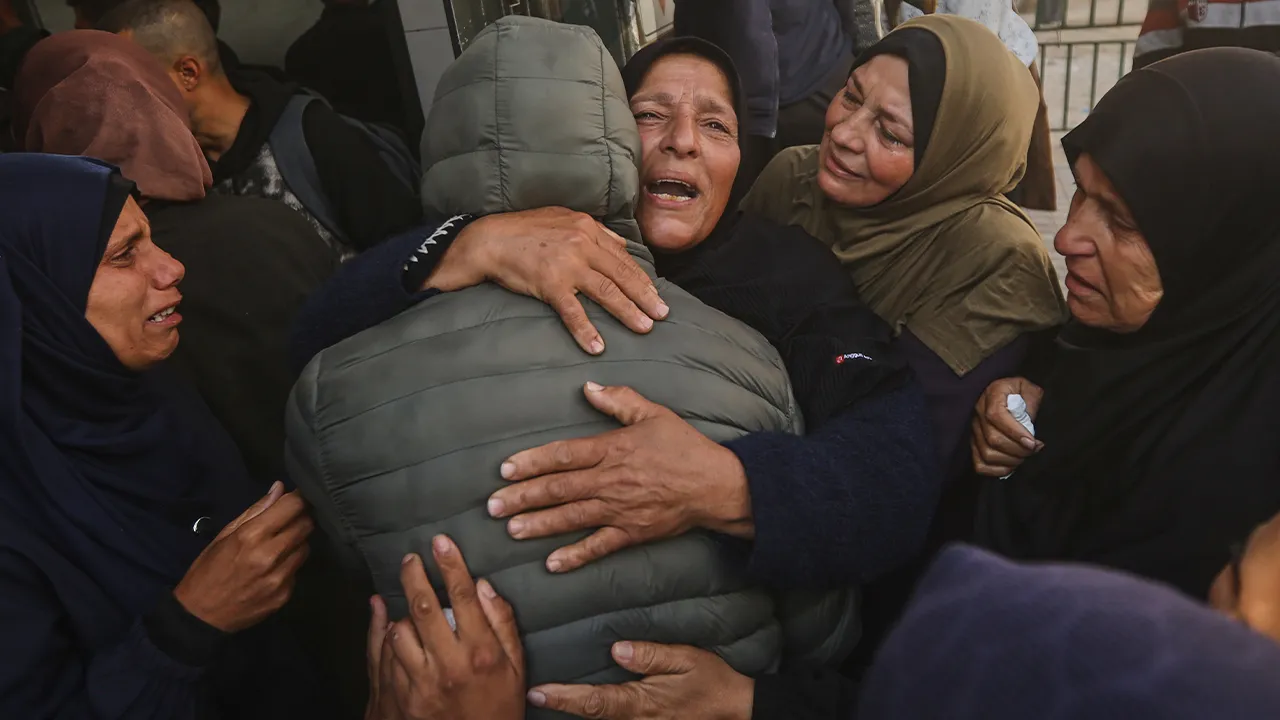Palestinians mourn over a mother and her children, killed in an Israeli strike, during their funeral at Al-Shifa Hospital in Gaza City, Saturday, April 25, 2026. (AP Photo/Yousef Alzanoun)
