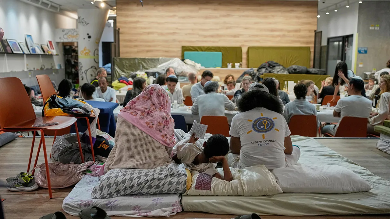 Families celebrate the Passover Eve dinner at a festive table in an underground shelter, in Ramat Gan, Israel, Wednesday, April 1, 2026. (AP Photo/Ohad Zwigenberg)