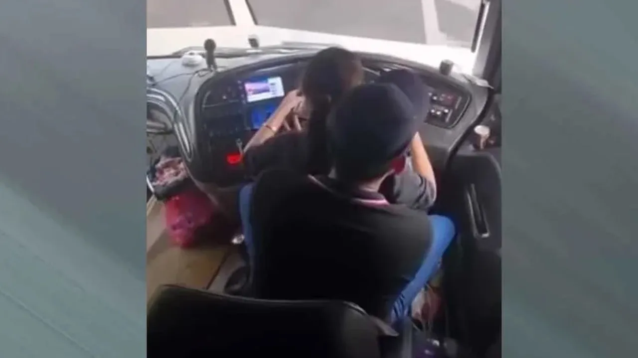 Tangkap layar rakaman video tular pemandu bas ekspres memangku wanita ketika kenderaan sedang bergerak.