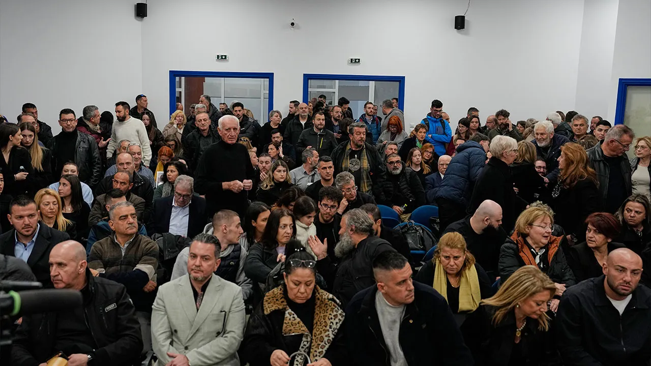 Relatives of victims of the Tempi train crash, wait for the start of the trial at the court in Larissa, Greece, Monday, March 23, 2026. (AP Photo/Thanassis Stavrakis)