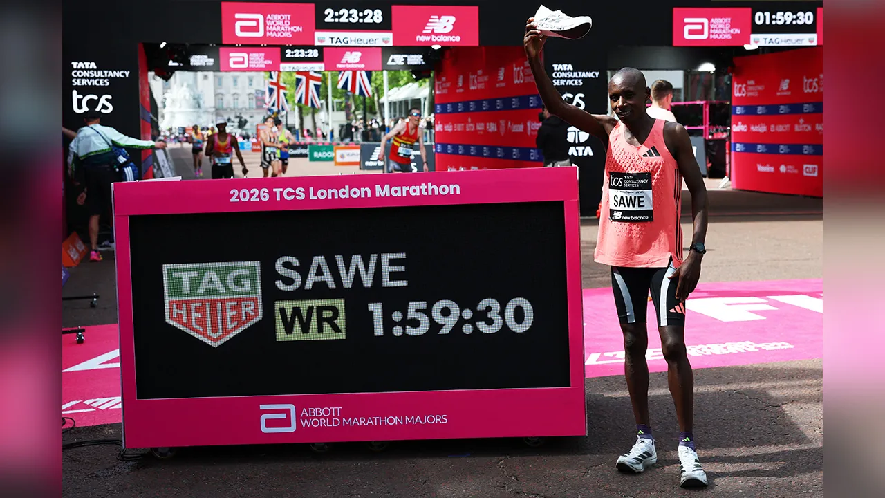 Athletics - London Marathon - London, Britain - April 26, 2026 Kenya's Sabastian Sawe celebrates with a shoe after winning the men's elite race and setting a new world record with a time of 01:59:30 REUTERS/Matthew Childs