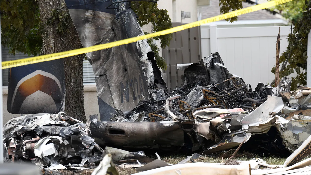 Wreckage from a small plane lies behind homes in the Grand Oaks subdivision after it crashed into residential backyards, in Florida, U.S., April 19, 2026. REUTERS/Octavio Jones