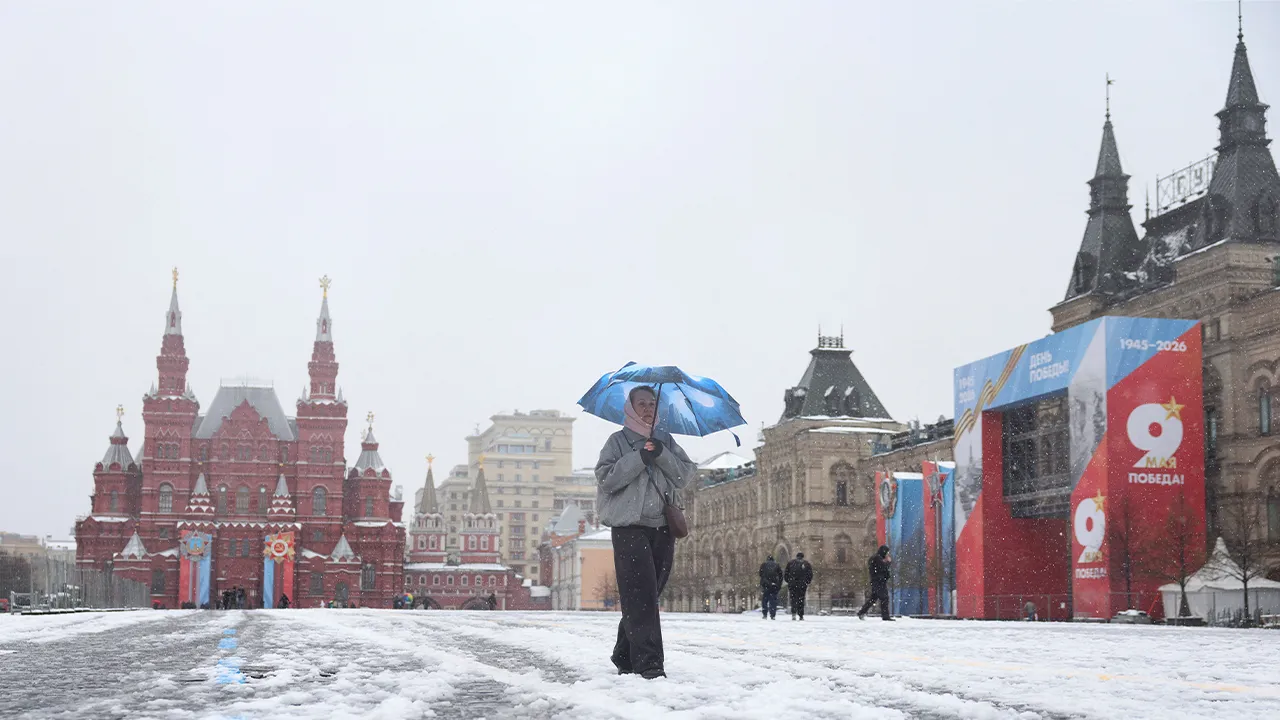 A woman walks across Red Square during a snowfall in Moscow, Russia April 27, 2026. REUTERS/Ramil Sitdikov