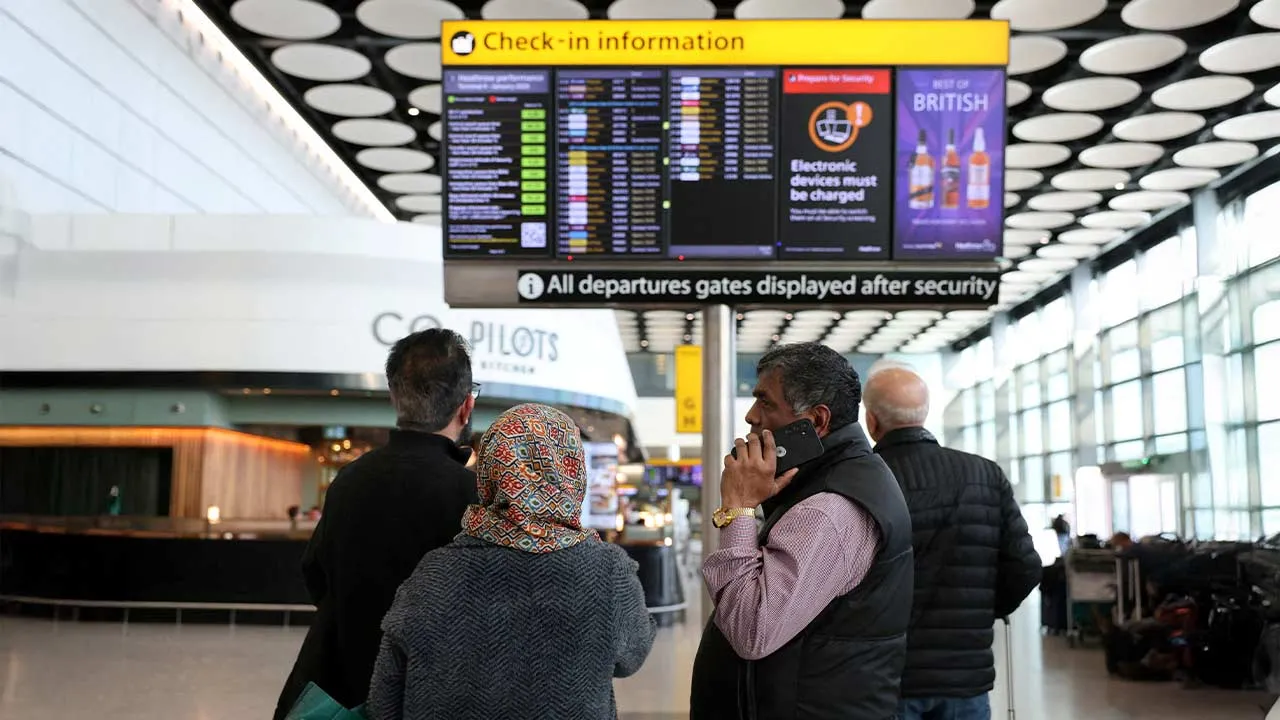 FILE PHOTO: Travellers check on a departure board displaying cancelled flights to Middle East countries amid the U.S.-Israel conflict with Iran, at Heathrow Airport Terminal 4, in Greater London, Britain, March 2, 2026. REUTERS/Isabel Infantes/File Photo