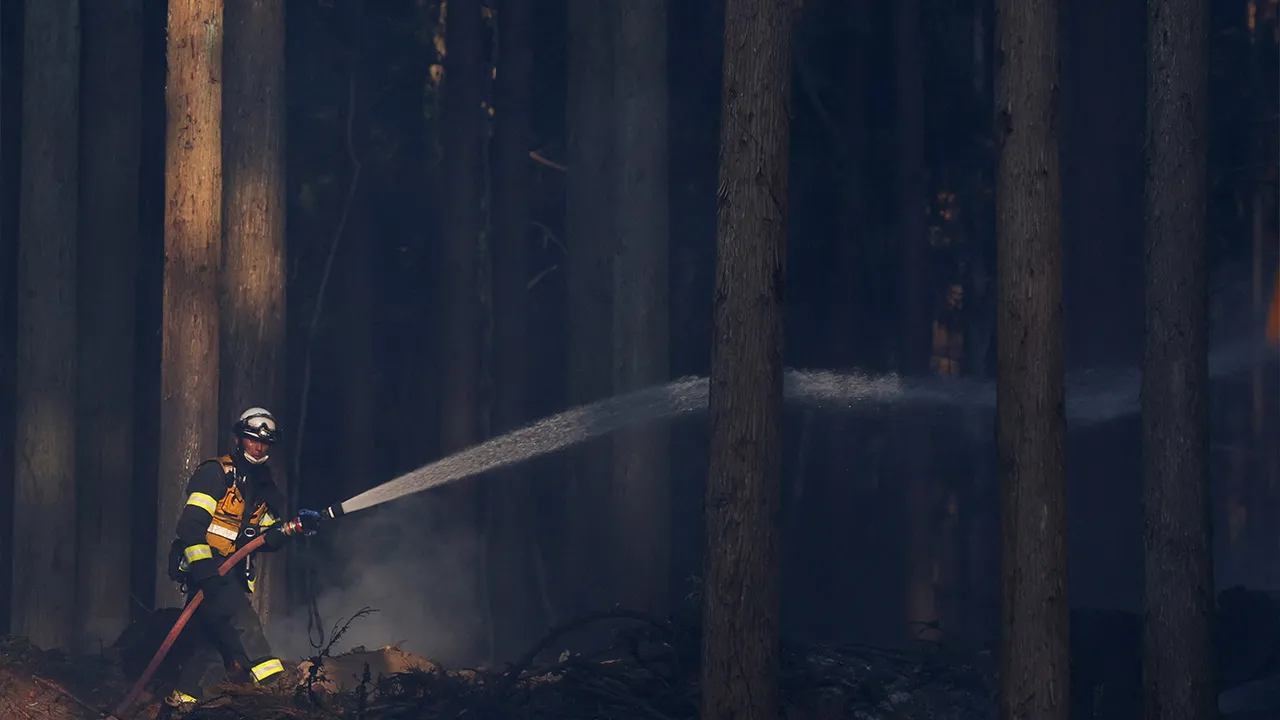 A firefighter works as wildfires continue in Otsuchi, Iwate Prefecture, Japan, April 25, 2026. REUTERS/Kim Kyung-Hoon