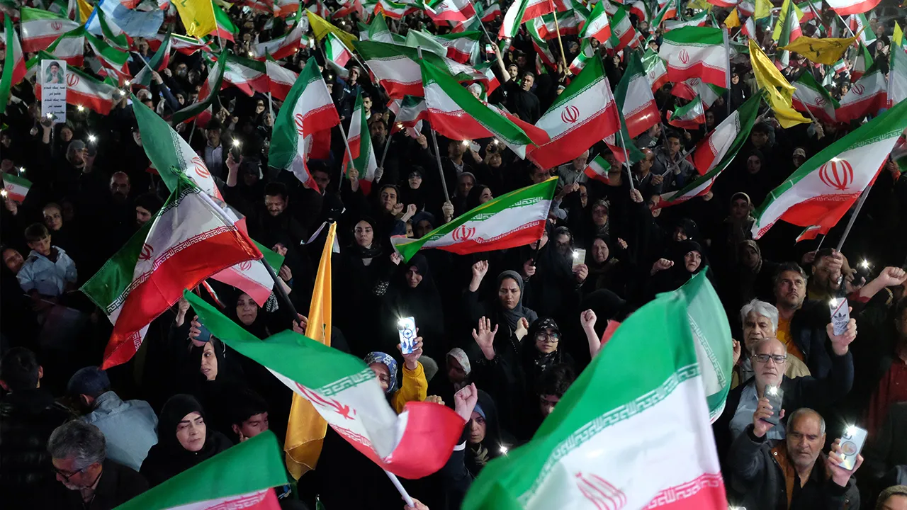 Pro-government demonstrators wave Iranian national flags at a gathering in Tehran, Iran, Saturday, April 11, 2026. (AP Photo/Vahid Salemi)